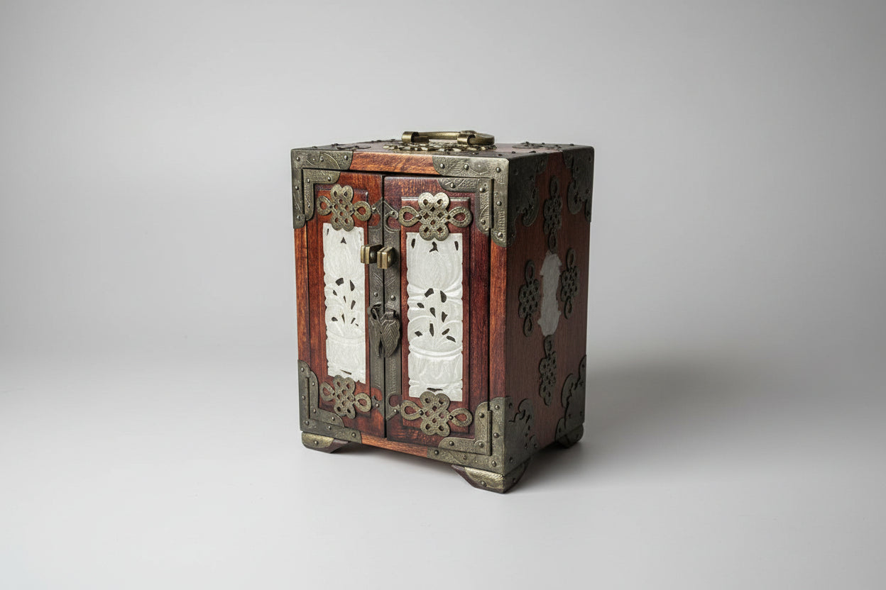 Decorative wooden box with metal accents on a dark surface