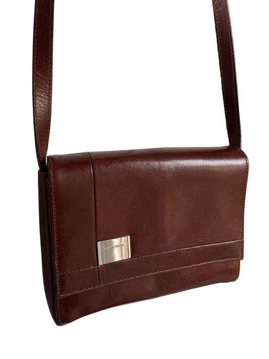 Brown leather shoulder bag with a gold clasp on a white background
