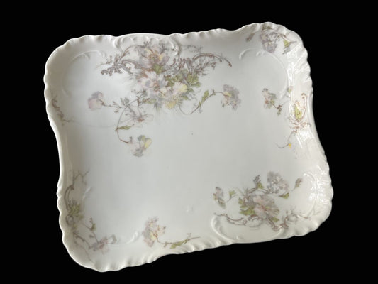 Decorative ceramic plate with floral patterns on a dark background